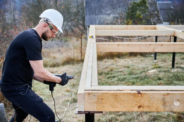 man-worker-building-wooden-frame-house-on-pile-fou-2026-01-07-01-00-58-utc